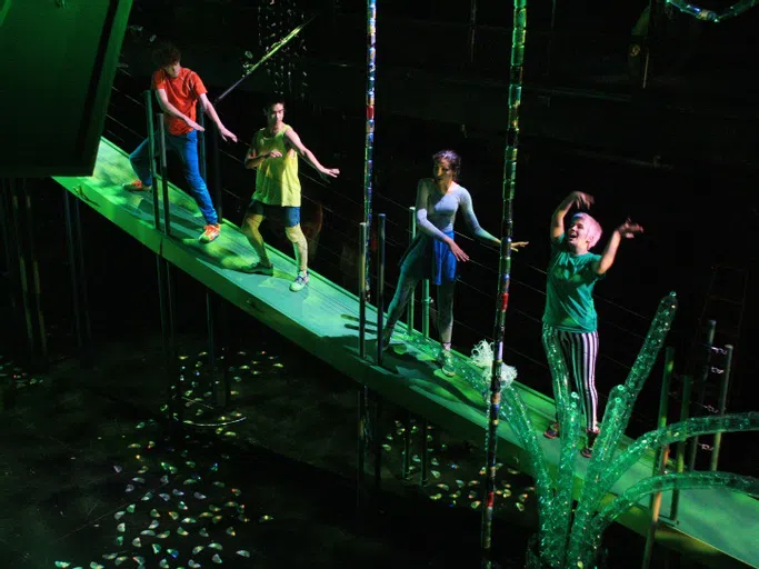 Students on a green bridge for an art installation