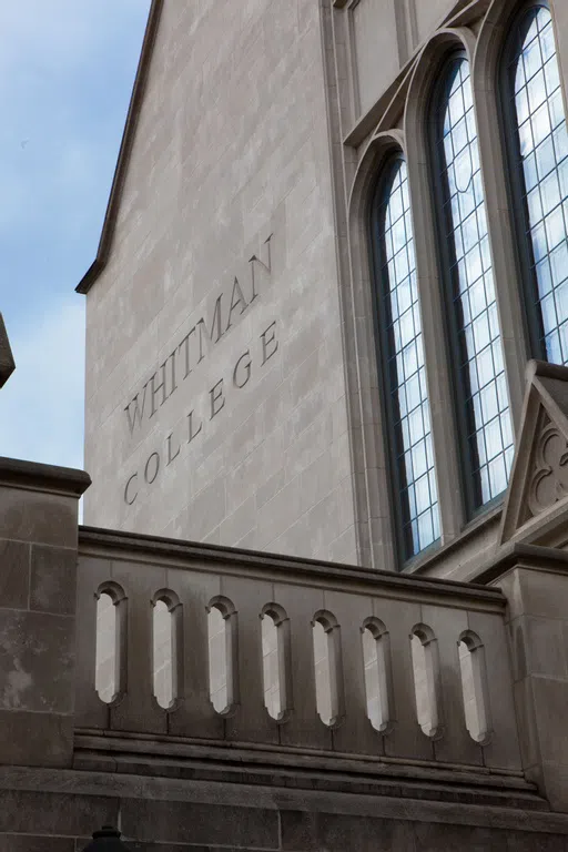 The name "Whitman College" etched on the side of the residential college. 