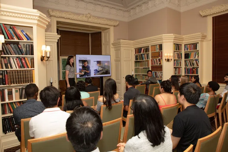 Individuals sitting in a room watching a presentation