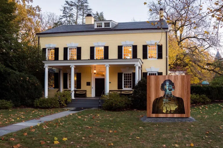 Image of MacLean house with installation sculpture in lawn.