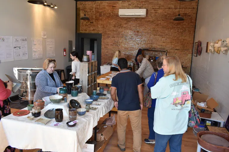 Visitors browsing and shopping student and studio work.