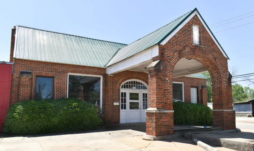 Outside image of the Filling Station event location brick building located just down from the main campus location toward the Cuthbert square.