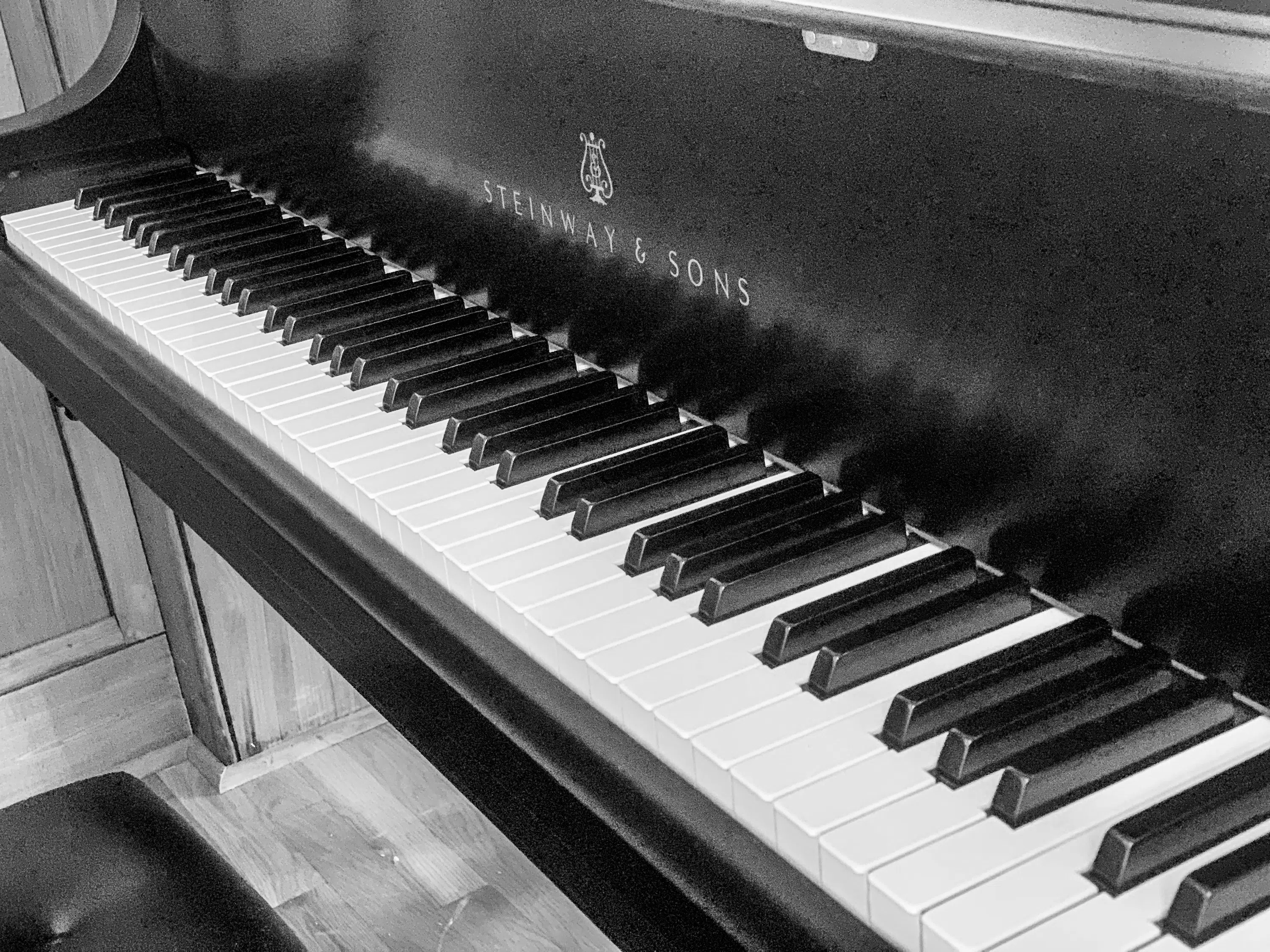 Photos of male playing the Steinway piano located in Jones Chapel and additional black and white image of the piano keys.