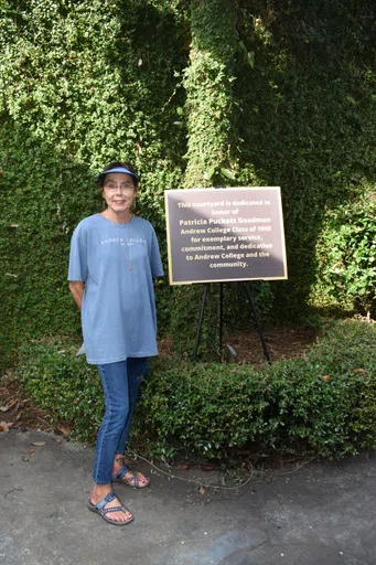 Photo of Patricia Puckett Goodman inside the courtyard bearing her name in 2021.