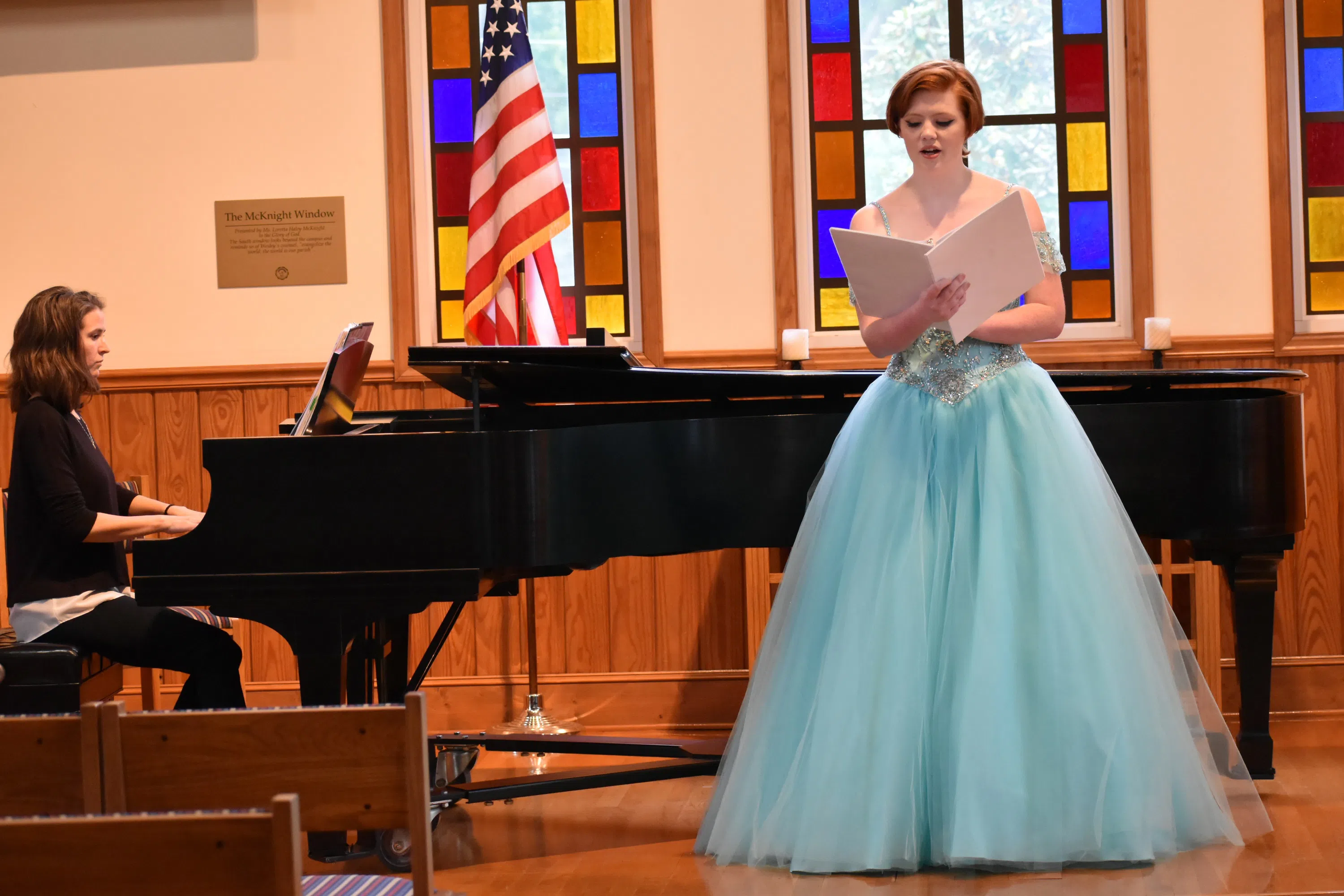 A student sings with piano accompaniment In Jones Chapel.