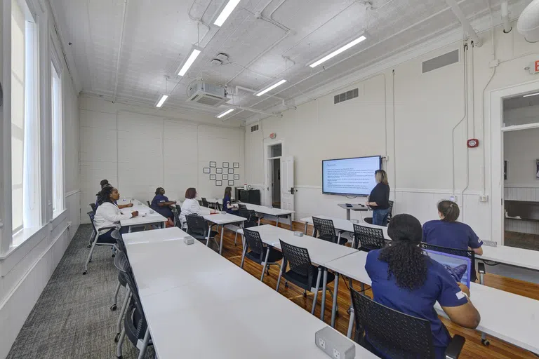 Wideshop image of classroom with students, professor, and large screen monitor in Staples Hall on the campus of Andrew College in Cuthbert, GA.