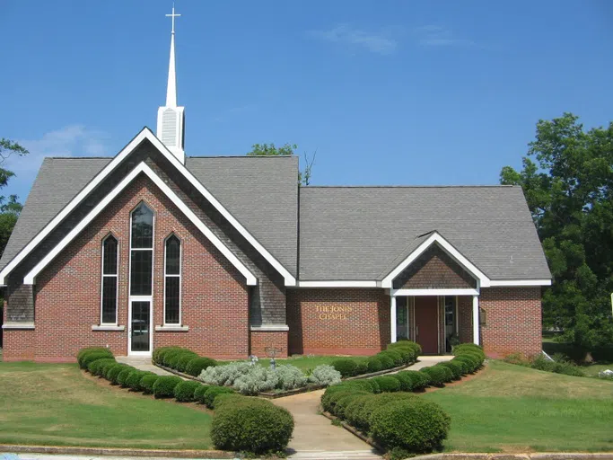 Exterior photo of Jones Chapel entrance with bushes and lawn.