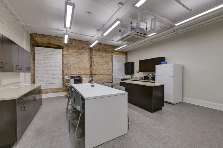 Photo of empty faculty break room with tables, microwave, refrigerator, and cabinets located on the third floor of Staples Hall on the campus of Andrew College in Cuthbert, GA.