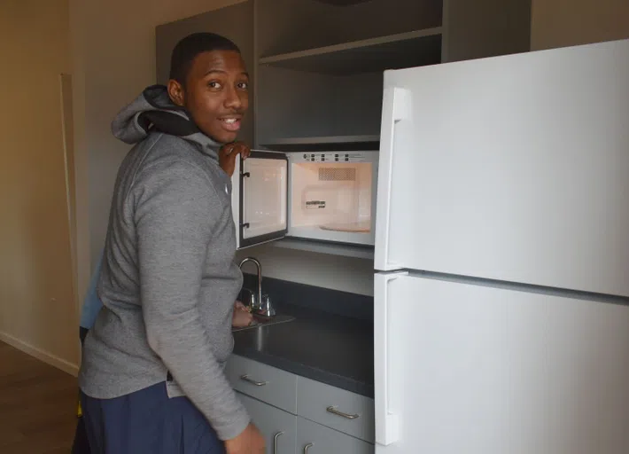 Image of student in a kitchen in one of the Patterson houses.