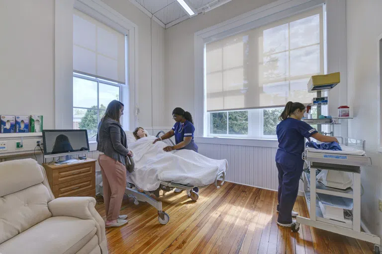 Photo of simulation lab with students working on the mannequins.