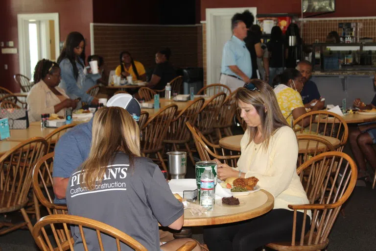 Families eat together in the dining hall.