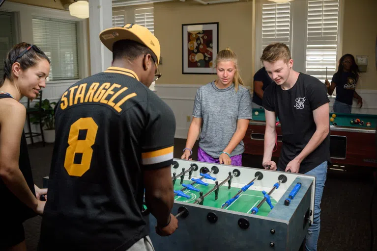 Students playing game inside the student center located on the bottom floor of Old Main.