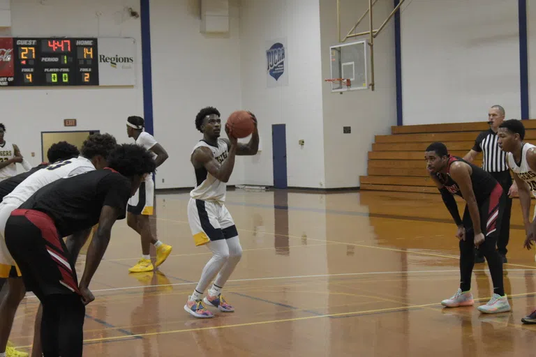 Andrew College basketball team player at the free throw line during a game against an opponent.