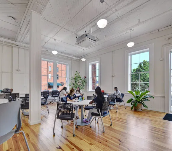 Photo of student study area in Staples Hall with students sitting at tables.