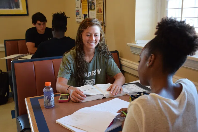 Photo of students smiling and having refreshments in Peg Leg Pete's, also known as the Tiger Stop.