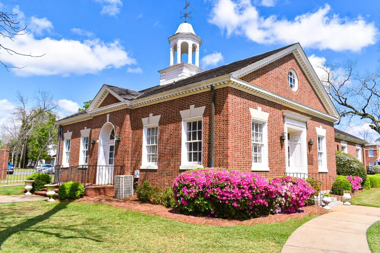 Image of exterior of Suarez Music Building located on the campus of Andrew College in Cuthbert, GA in spring with azaleas blooming.