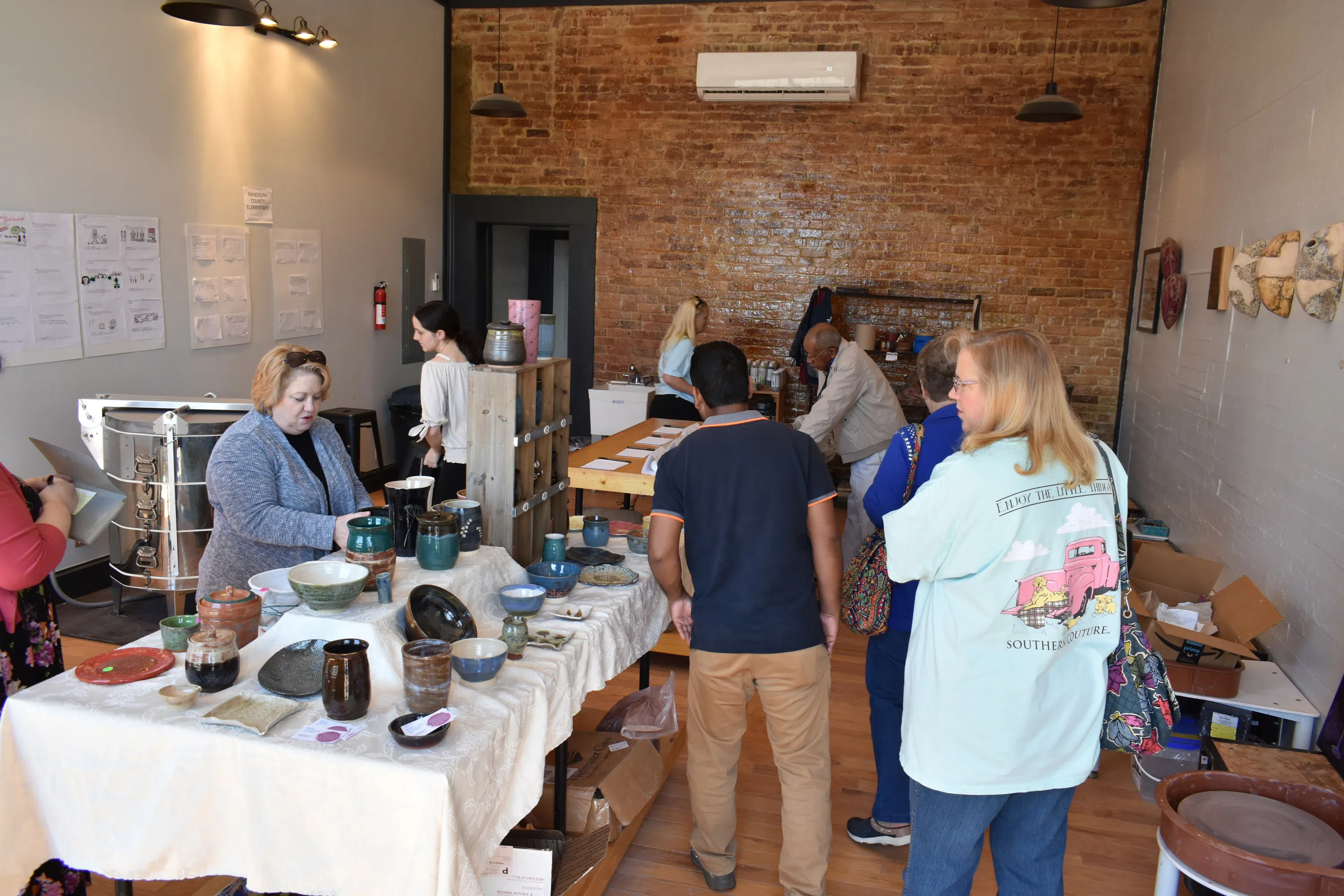 Visitors browsing and shopping student and studio work.