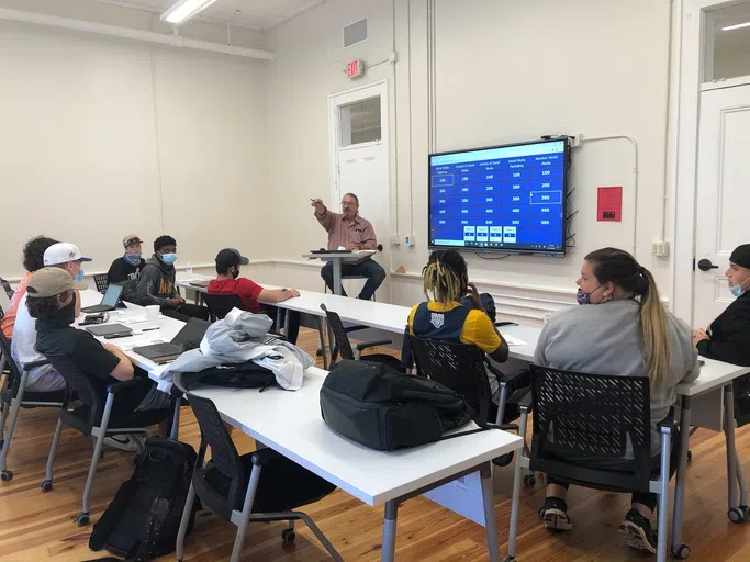 Dr. Kortbawi teaches a business class in a Staples Hall classroom.