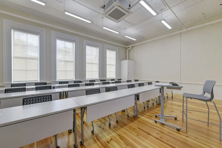 Photo of an empty classroom with seating and desks located in Staples Hall on the campus of Andrew College in Cuthbert, GA.