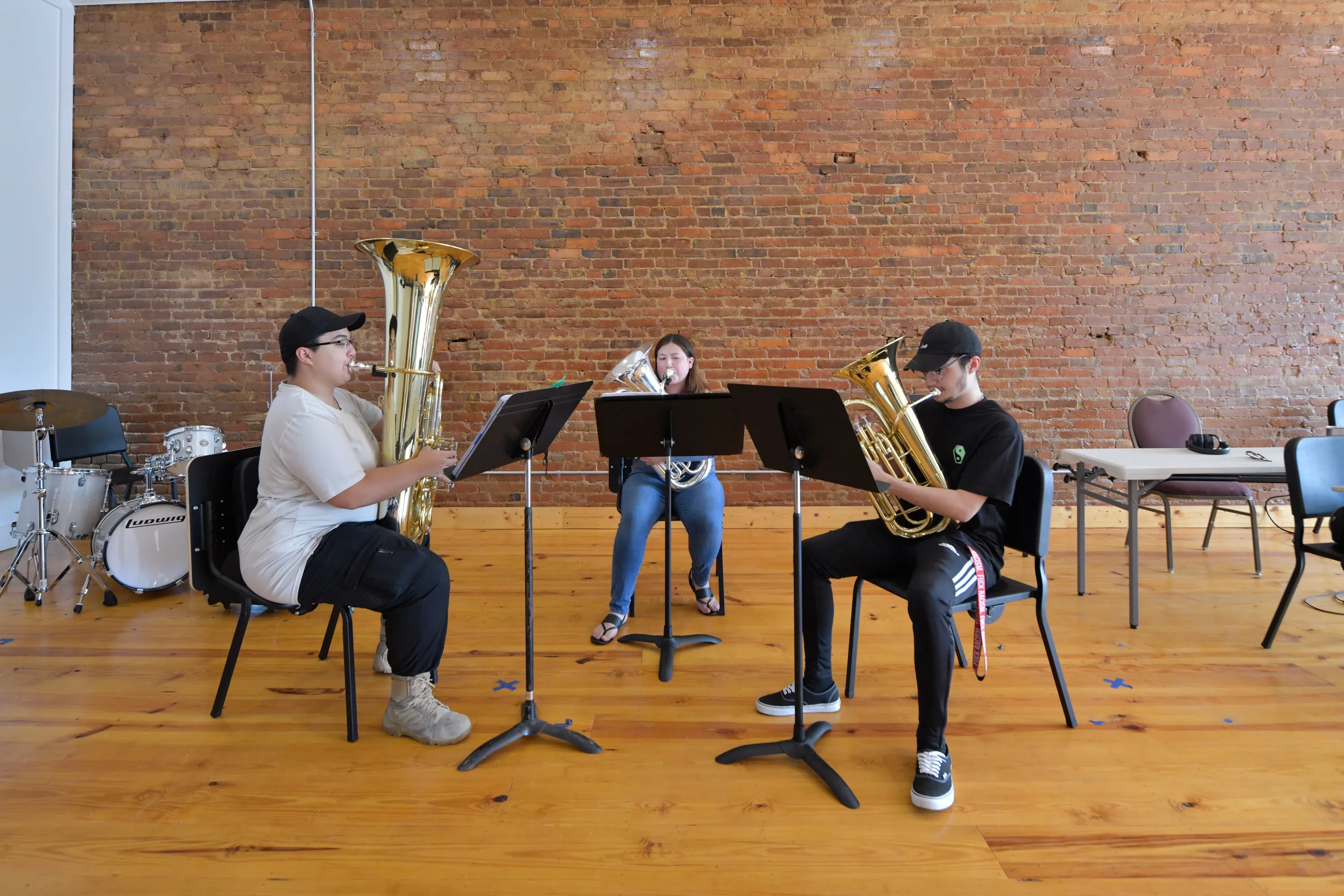 Students rehearse with instruments inside the Richard B. Taylor Music Center.