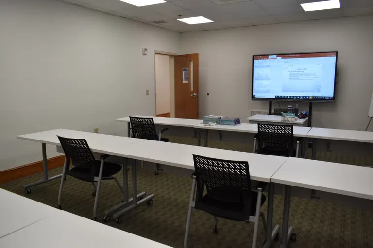 Image of classroom inside Jones Chapel on first floor with desks, chairs, books, and large computer screen with intubation study information depicted.