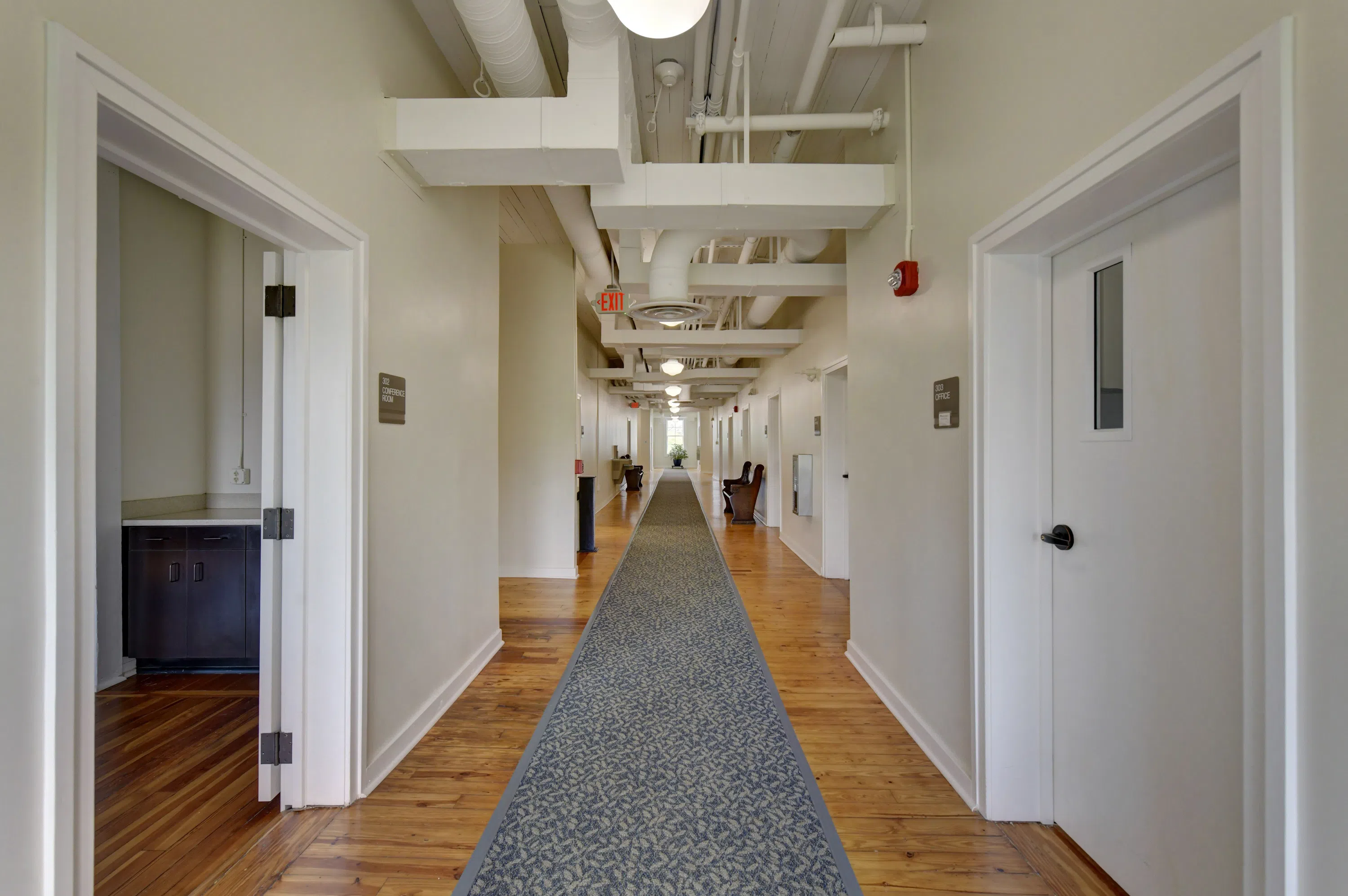 Photo of long empty hallway with doors located on the third floor of Staples Hall on the campus of Andrew College in Cuthbert, GA.