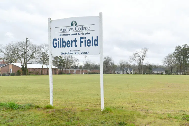 Outside shot of Gilbert Field with signage that reads  "Andrew College Jimmy and Crispin Gilbert Field dedicated October 20, 2007." 