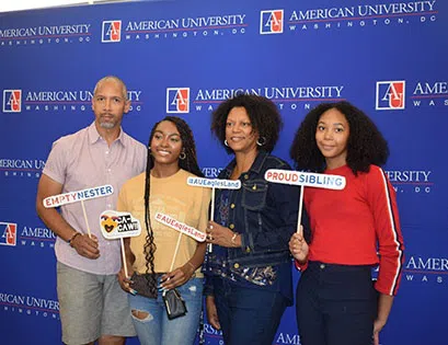 Family poses for photo during Move in at American University