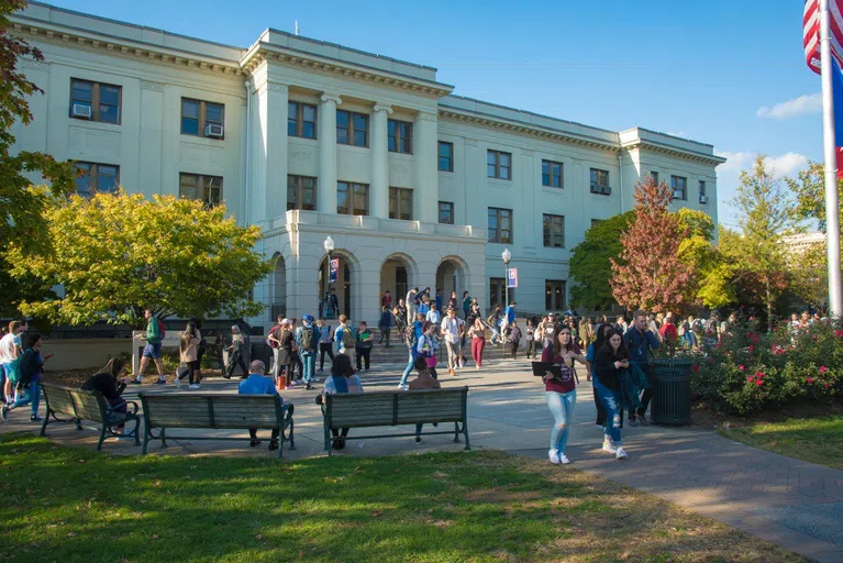 The front of the Mary Graydon Center (MGC) with numerous students walking into and around it, coming and going from class.