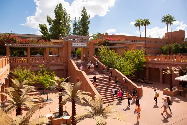 A stairway leads to a sunken courtyard and underground entrance to Hayden Library.