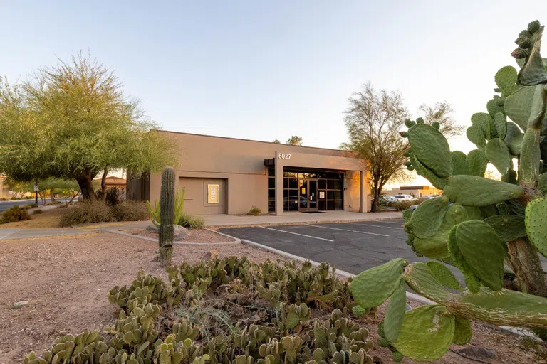 Cacti plants appear in the foreground of an empty parking lot in front of the Ironwood building.