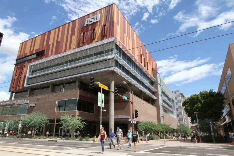 Students crossing the street in front of the Cronkite Building.