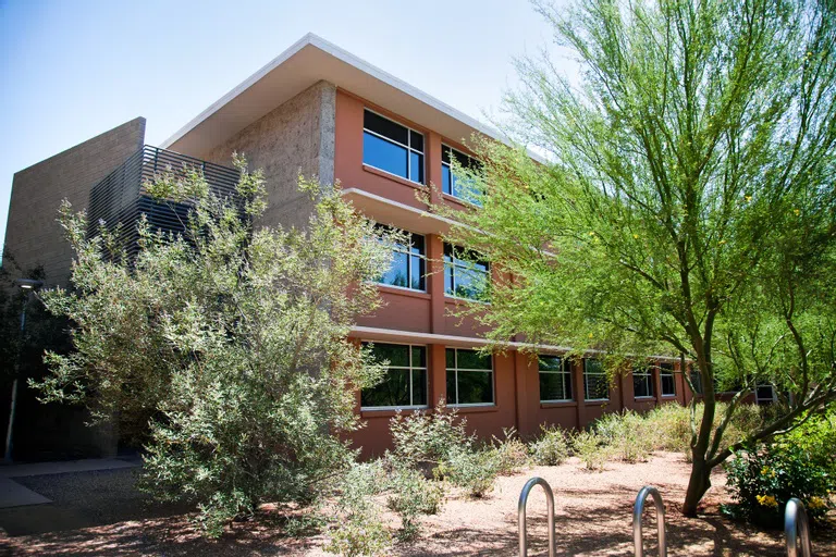 Exterior of Sutton Hall, with trees in front of the building. 