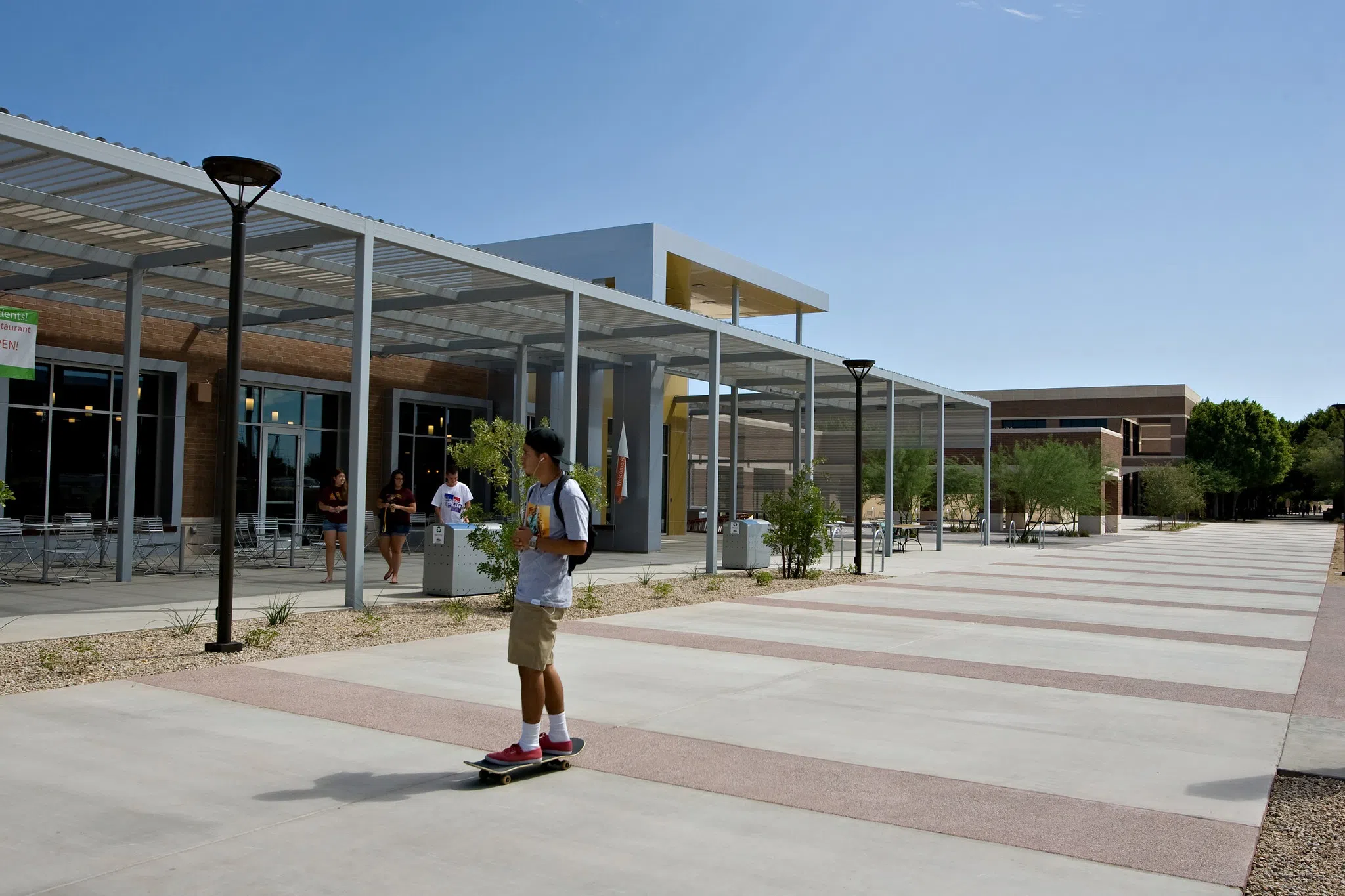 Student on skateboard in front of Verde Dining Pavilion