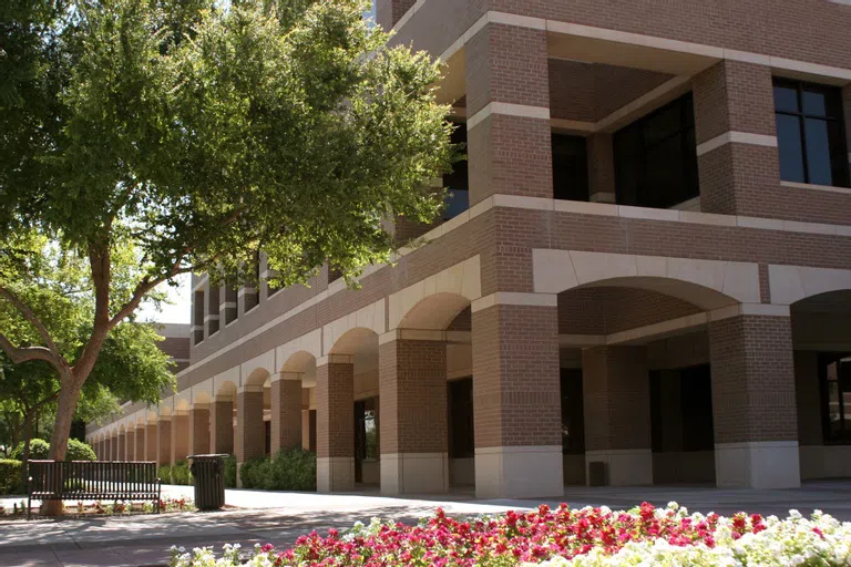 Arched brick columns create a covered walkway around Faculty/Administration Building.