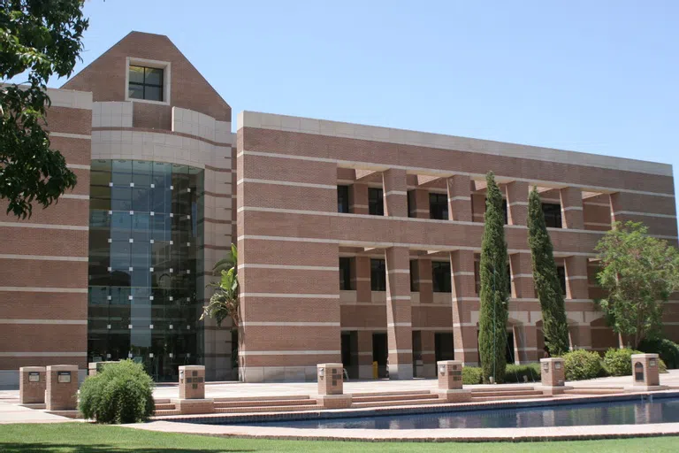 A reflection pool is in front of the three-story Fletcher library.