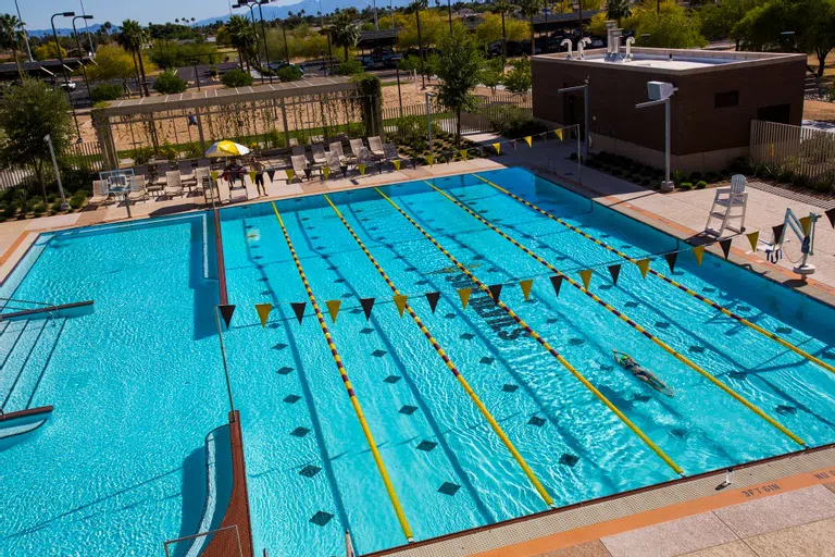 Aerial view of the pool with someone swimming laps. 