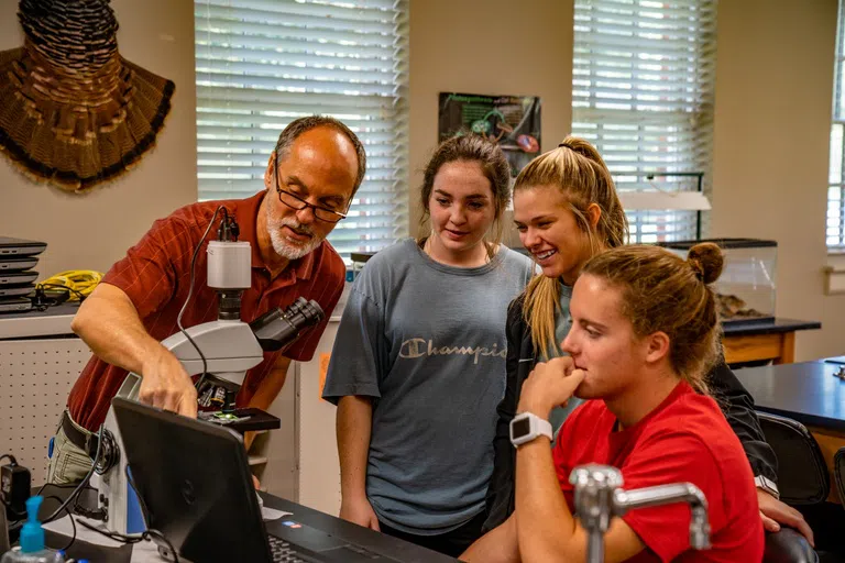 Professor assists students during class