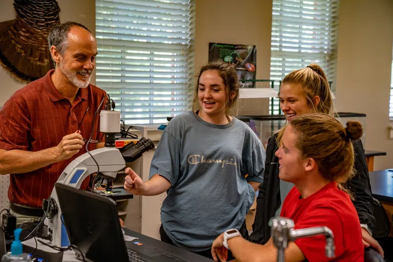 Professor Assists Students In Science Lab