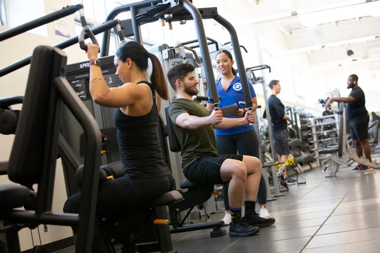 Students using weight machines