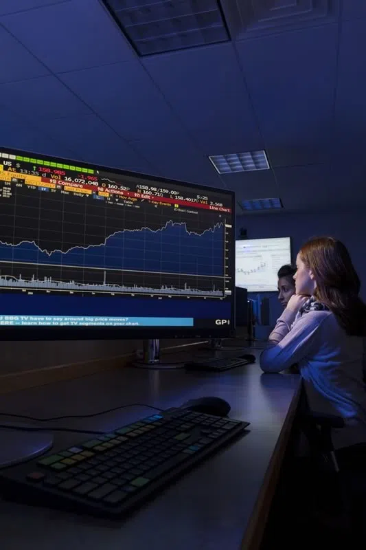 Students using computer monitors in the Zurack Trading Room