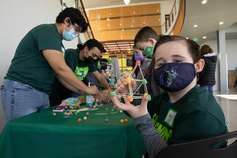 Thomas J. Watson College of Engineering and Applied Science annual Community Day, Reimagining the Possible, which is part of Engineers Week 2022, that took place at the Center of Excellence and Engineering and Science buildings of the Innovative Technologies Complex, Saturday, February 26, 2022. 8-year-old Peyton Musok shows off his tetrahedral.