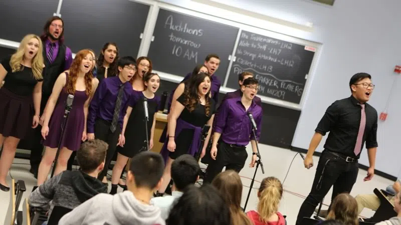 Students participating in a singing production