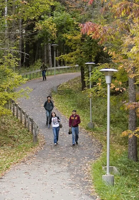 Students walking on the apartment community pathway.
