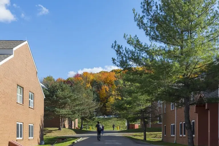 Students walking on the path between the apartment community buidlings