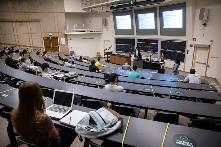 Remington T. Curtis, Ph.D., Assistant Professor in the School of Management, teaches an accounting course at Lecture Hall at the beginning of the 2020 Fall semester, September 1, 2020. Prof. Curtis and the students wore masks and practiced social distancing to help prevent the spread of COVID-19.