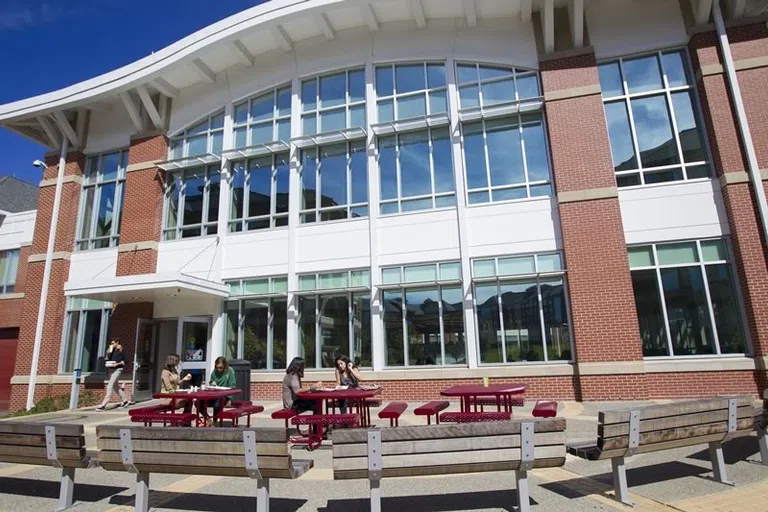 Students sit outside the dining hall together 