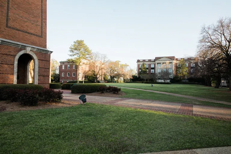 Ground level bell tower photo looking on to academic buildings 