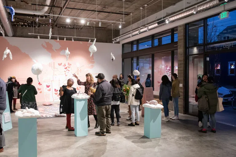 A crowd gathers at Christine Wong Yap’s exhibition opening.