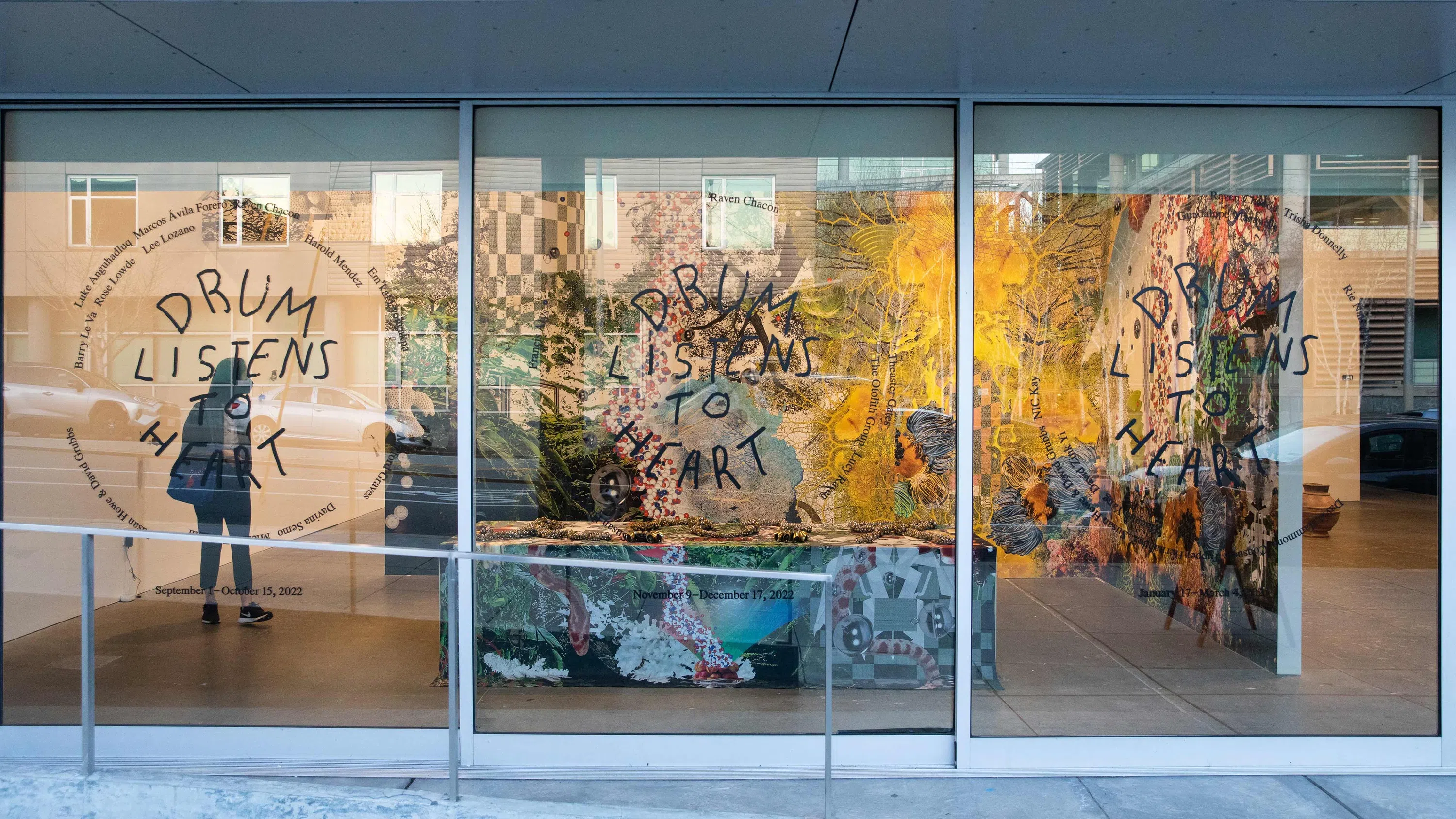 Exterior street level view of the windows looking into an art gallery. 